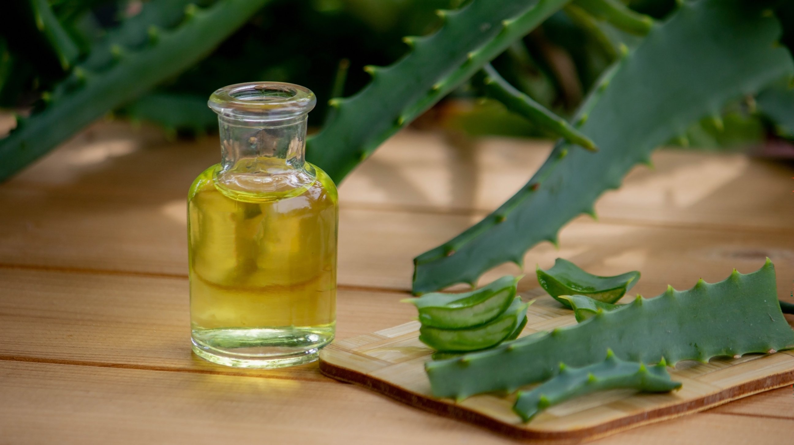 aloe vera essential oil on a wooden background, juice.